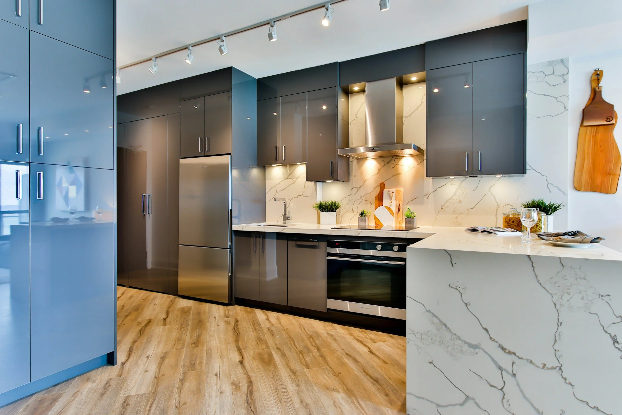 Modern kitchen with dark cabinetry and marble backsplash