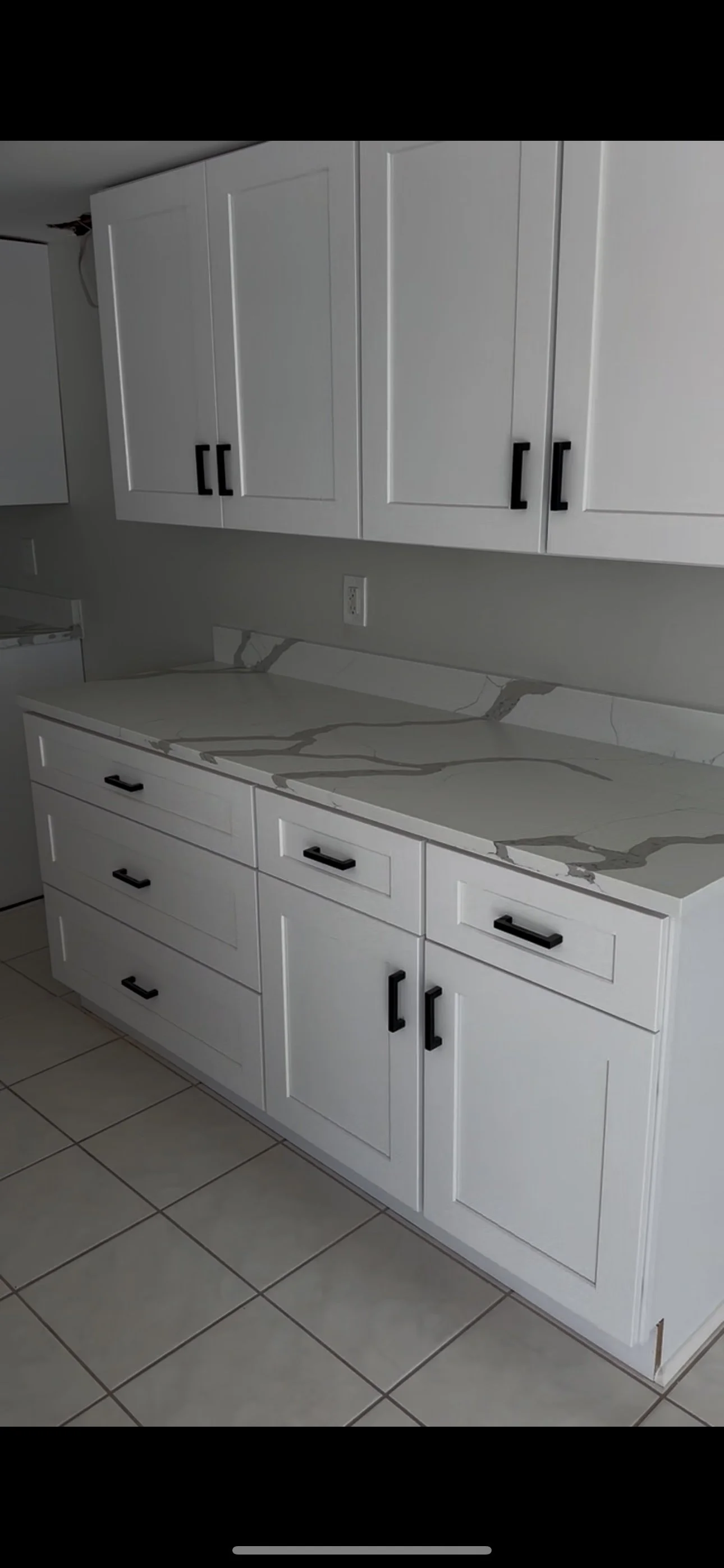Kitchen remodel with white shaker cabinets and quartz countertops
